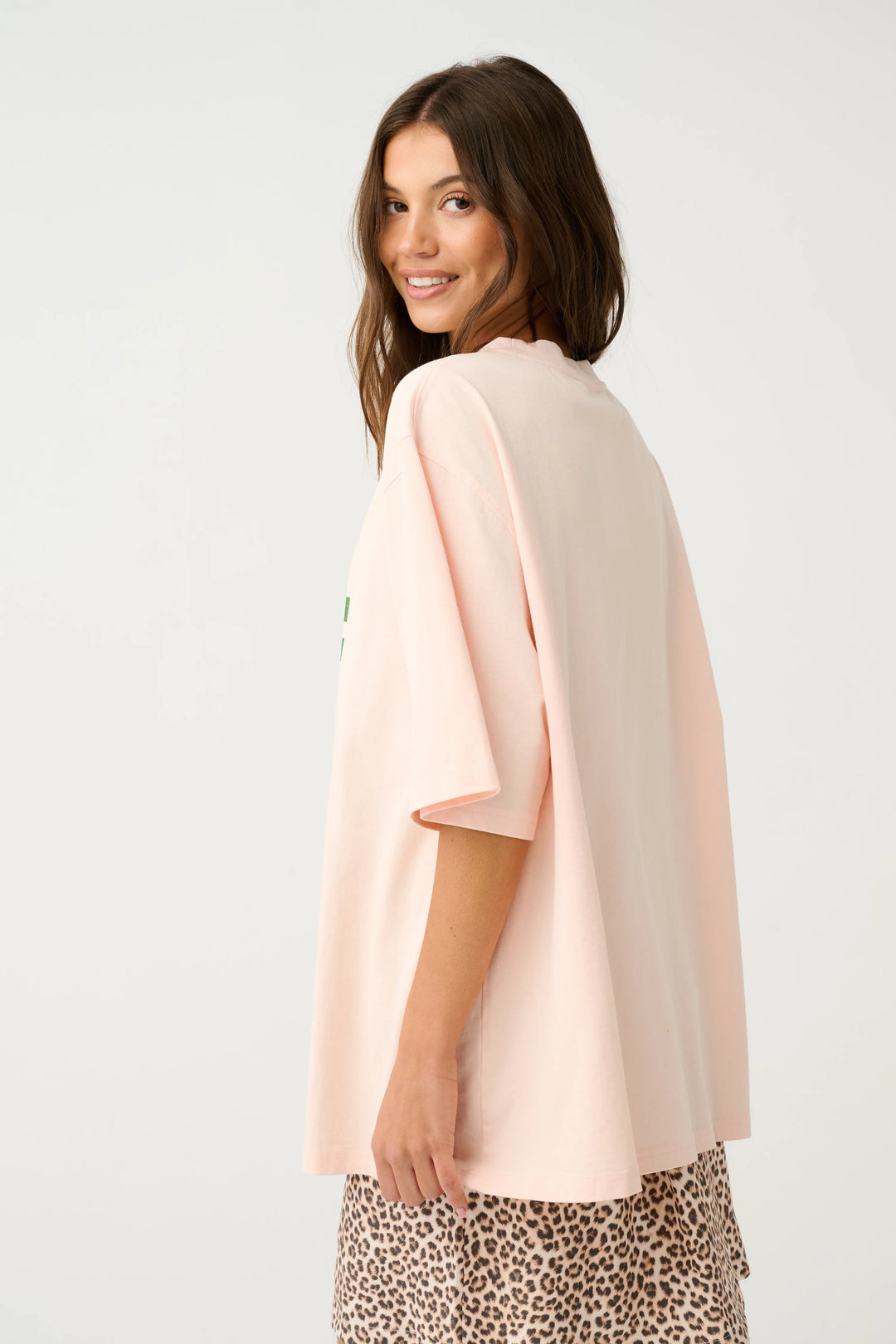 Woman wearing a light pink blouse with a white background