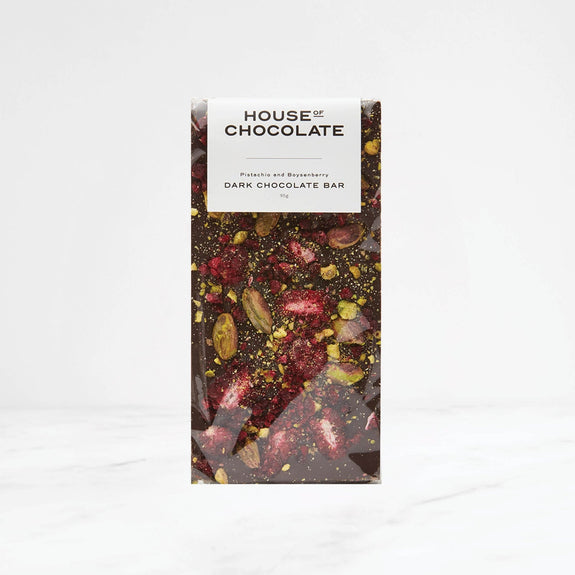 Dark chocolate bar with visible nuts and berries on a white background