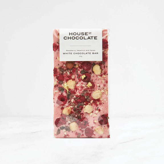 White chocolate bar with visible ingredients on a white background