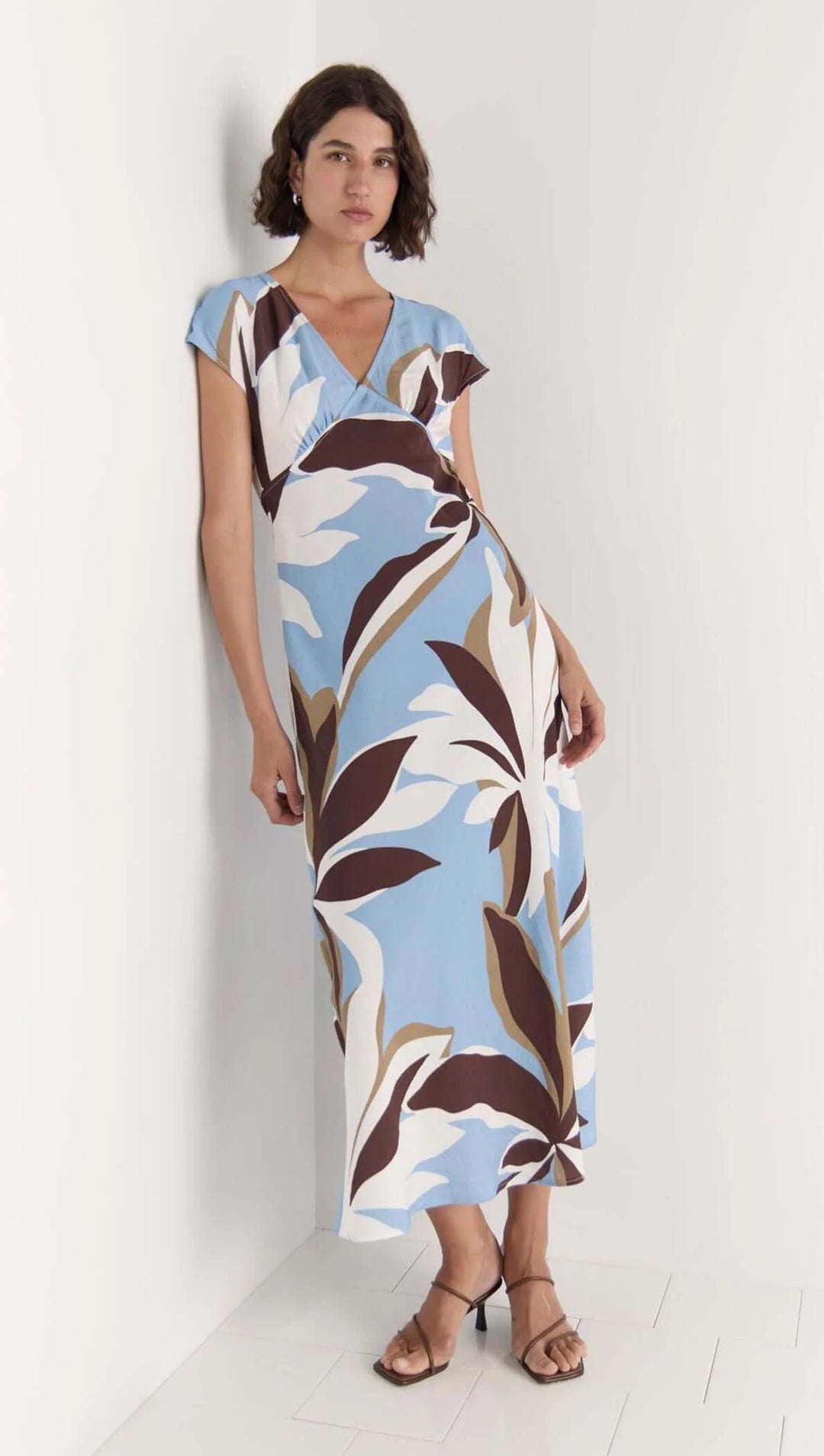 Woman wearing a floral dress with a white background
