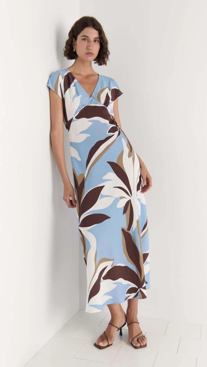 Woman wearing a floral dress with a white background