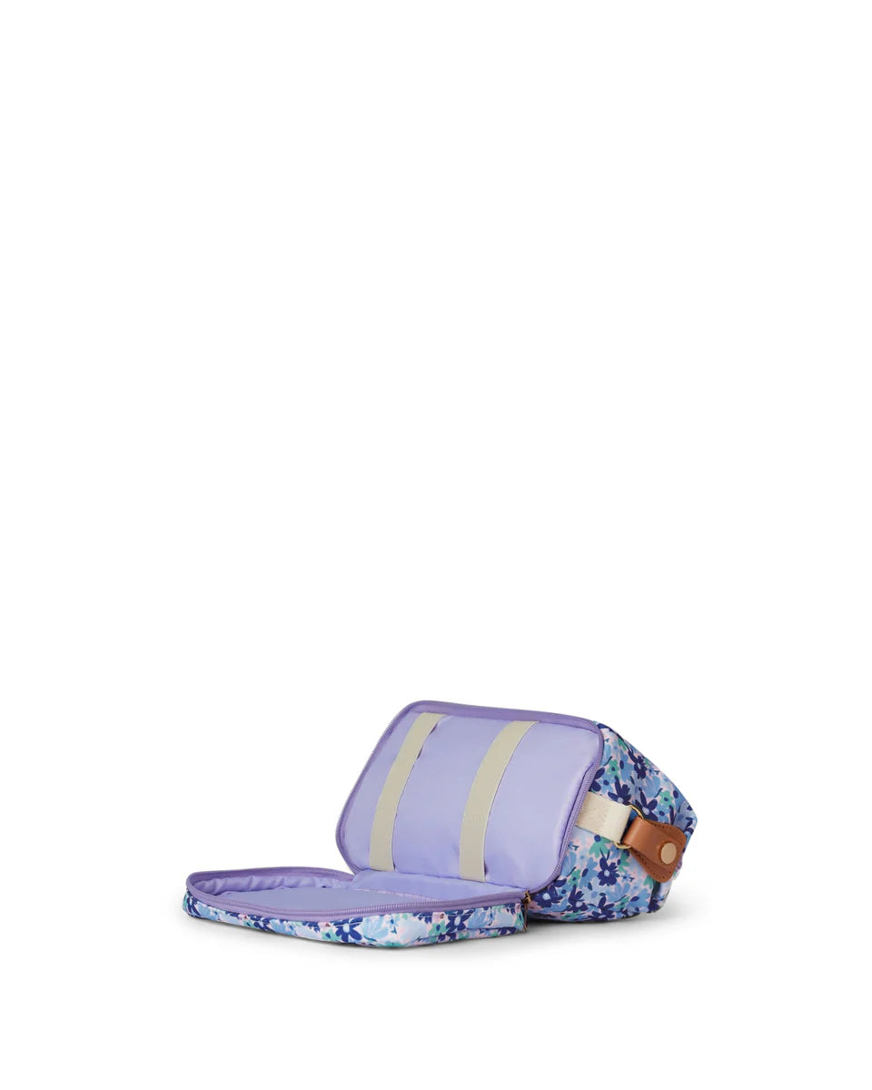 Floral-patterned bag with a purple strap on a white background