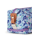 Floral-patterned toiletry bag with a brown handle on a white background
