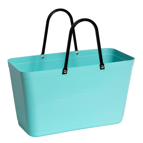 Turquoise tote bag with black handles on a white background