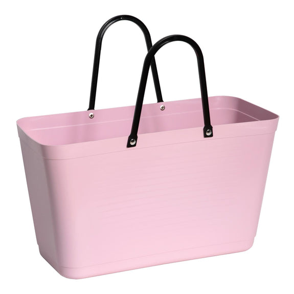 Pink plastic tote bag with black handles on a white background