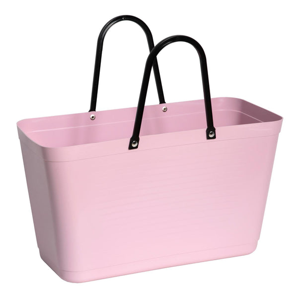 Pink plastic tote bag with black handles on a white background
