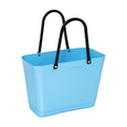 Blue tote bag with black handles on a white background