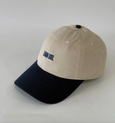 Beige and navy cap with 'LAWN GOD' embroidery on a light gray background