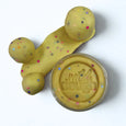 Yellow play dough with colorful sprinkles and a container labeled 'wild dough' on a white background