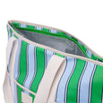 Close-up of a green and blue striped cooler bag with white interior