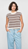 Woman wearing a striped shirt and jeans on a plain background