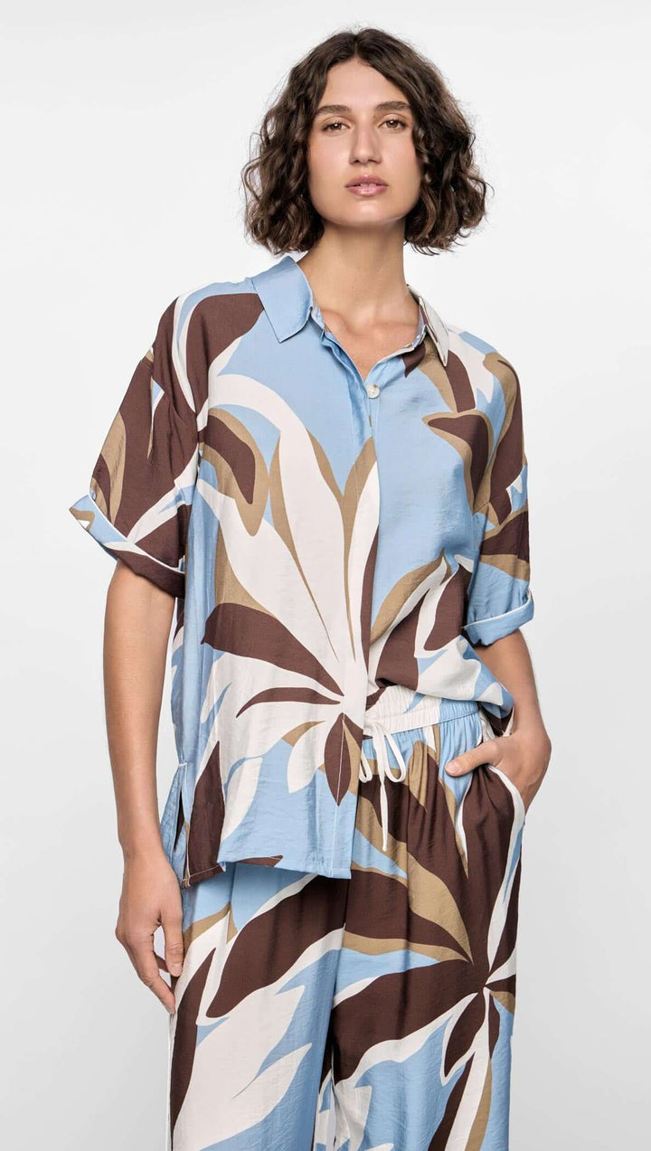 Woman wearing a patterned outfit with a white background
