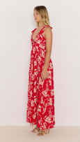 Woman wearing a red floral dress against a white background