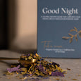 Tea leaves on a spoon with 'Good Night' tea packaging in the background