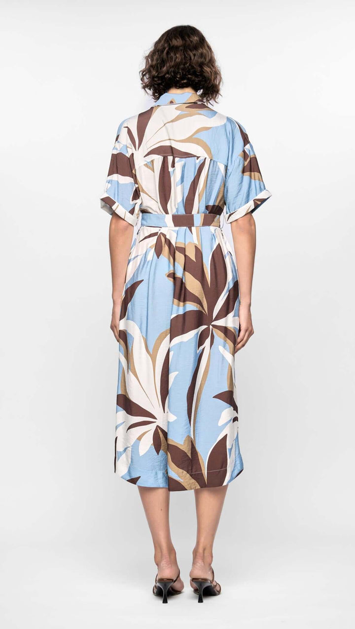 Woman wearing a patterned dress on a white background