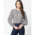 Woman wearing a leopard print blouse and jeans on a white background