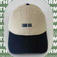 Two-tone cap with 'Lawn God' text on a green background with text overlay