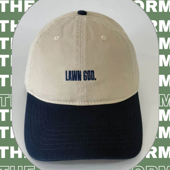 Two-tone cap with 'Lawn God' text on a green background with text overlay