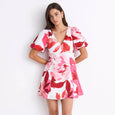 Woman wearing a pink floral dress on a white background