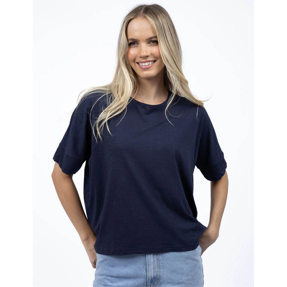 Woman wearing a navy blue t-shirt on a white background