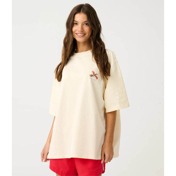 Woman wearing a cream-colored t-shirt with a small design on a white background