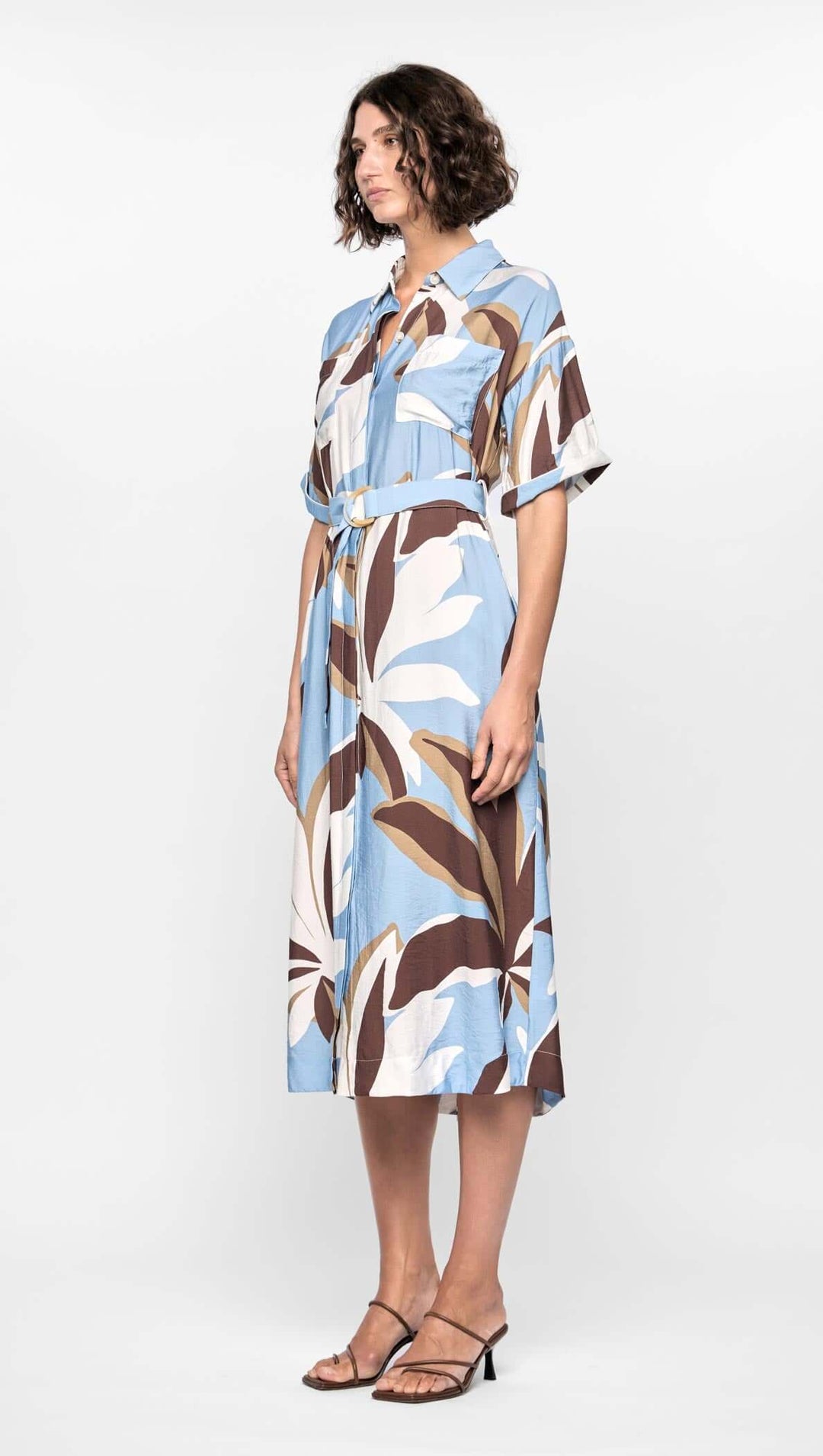 Woman wearing a patterned dress on a white background