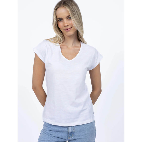 Woman wearing a plain white t-shirt and blue jeans on a white background