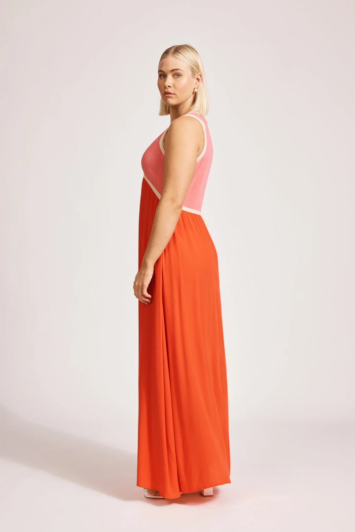 Woman wearing a Eb & Ive pink and orange dress on a white background