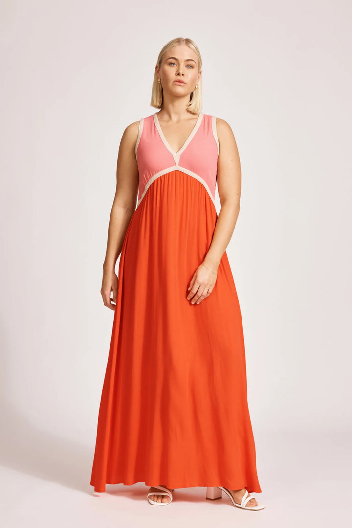 Woman wearing a Eb & Ive pink and orange dress on a white background