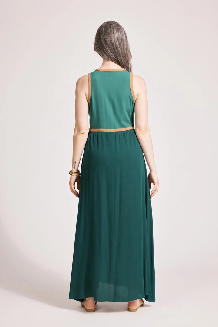 Woman wearing a green sleeveless Eb & Ive dress against a plain background