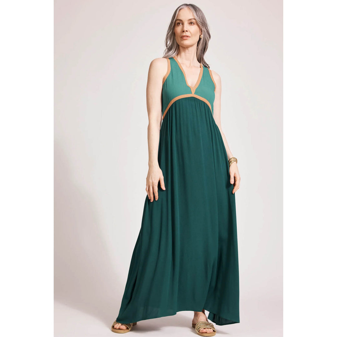 Woman wearing a green EB\b & Ive dress with orange accents on a white background