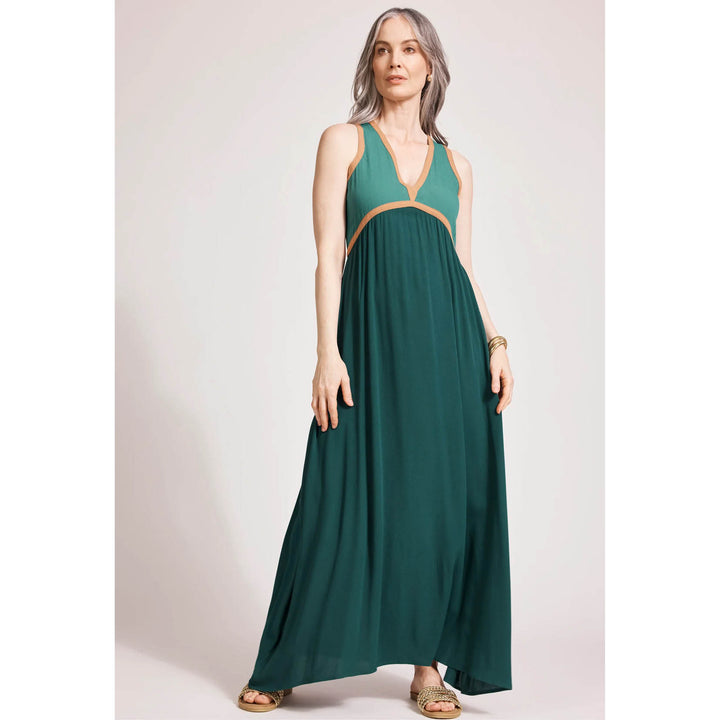 Woman wearing a green EB\b & Ive dress with orange accents on a white background
