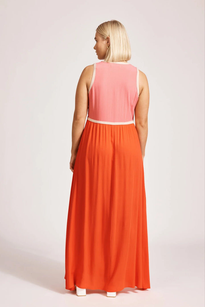 Woman wearing a Eb & Ive pink  and orange dress on a white background