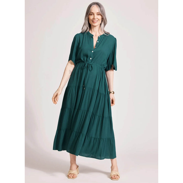 Woman wearing a green Eb & Ive dress against a plain background