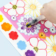 Colorful flower stickers on a sheet with a hand holding a marker.