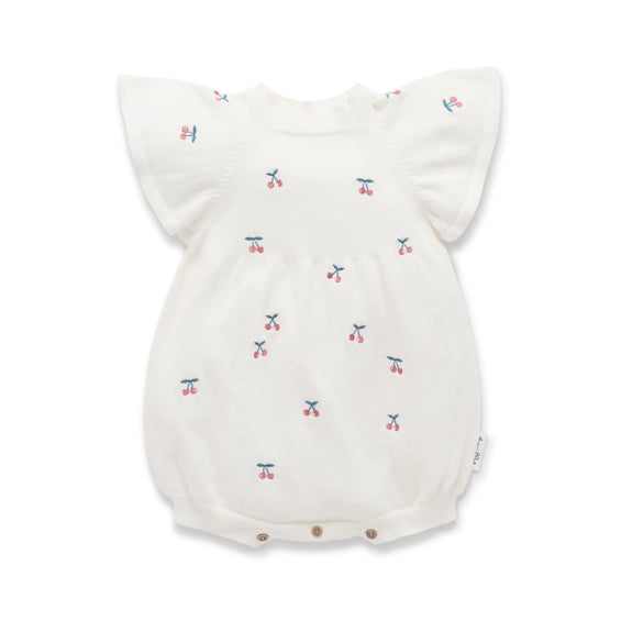 Baby romper with cherry pattern on a white background