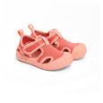 Pair of coral crywolf children's sandals on a white background