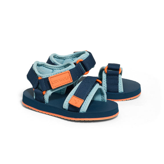 Pair of blue and orange crywolf beach sandals on a white background
