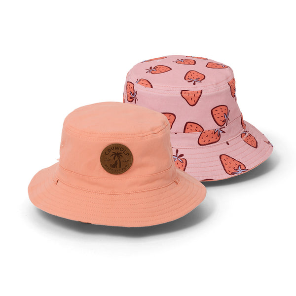 Two crywolf bucket hats, one peach and one pink with strawberry pattern, on a white background.