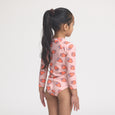 Girl wearing a strawberry-patterned crywolf swimsuit on a white background