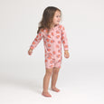 Crywolf Child wearing a pink strawberry-patterned onesie on a white background