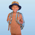 Child wearing a brown outfit with a blue backpack against a light blue background