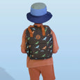 Person wearing a dinosaur-patterned backpack and blue bucket hat on a light blue background