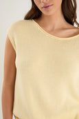 Yellow sleeveless top worn by a person on a plain background