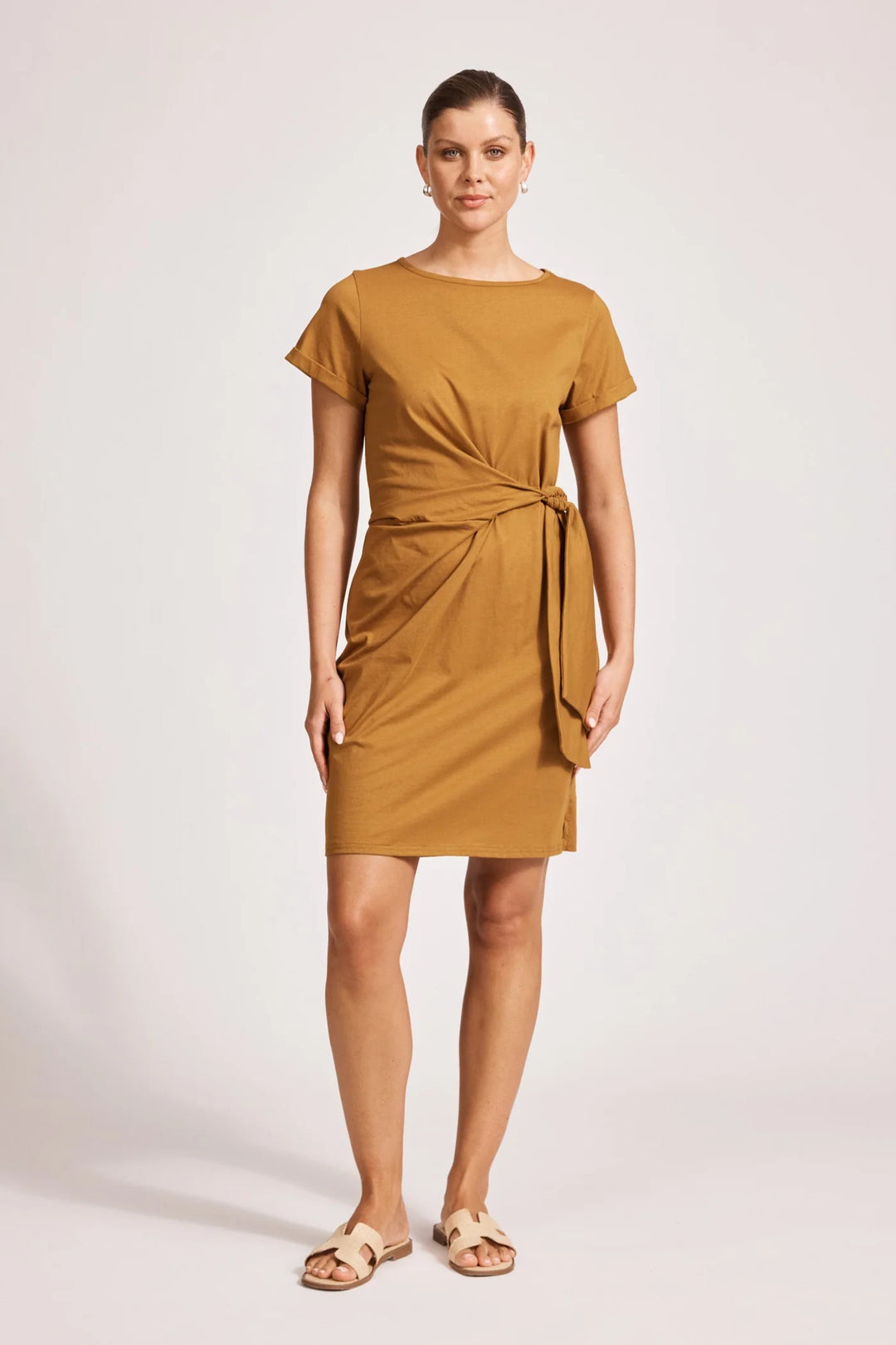 Woman wearing a eb & ive mustard yellow dress on a white background