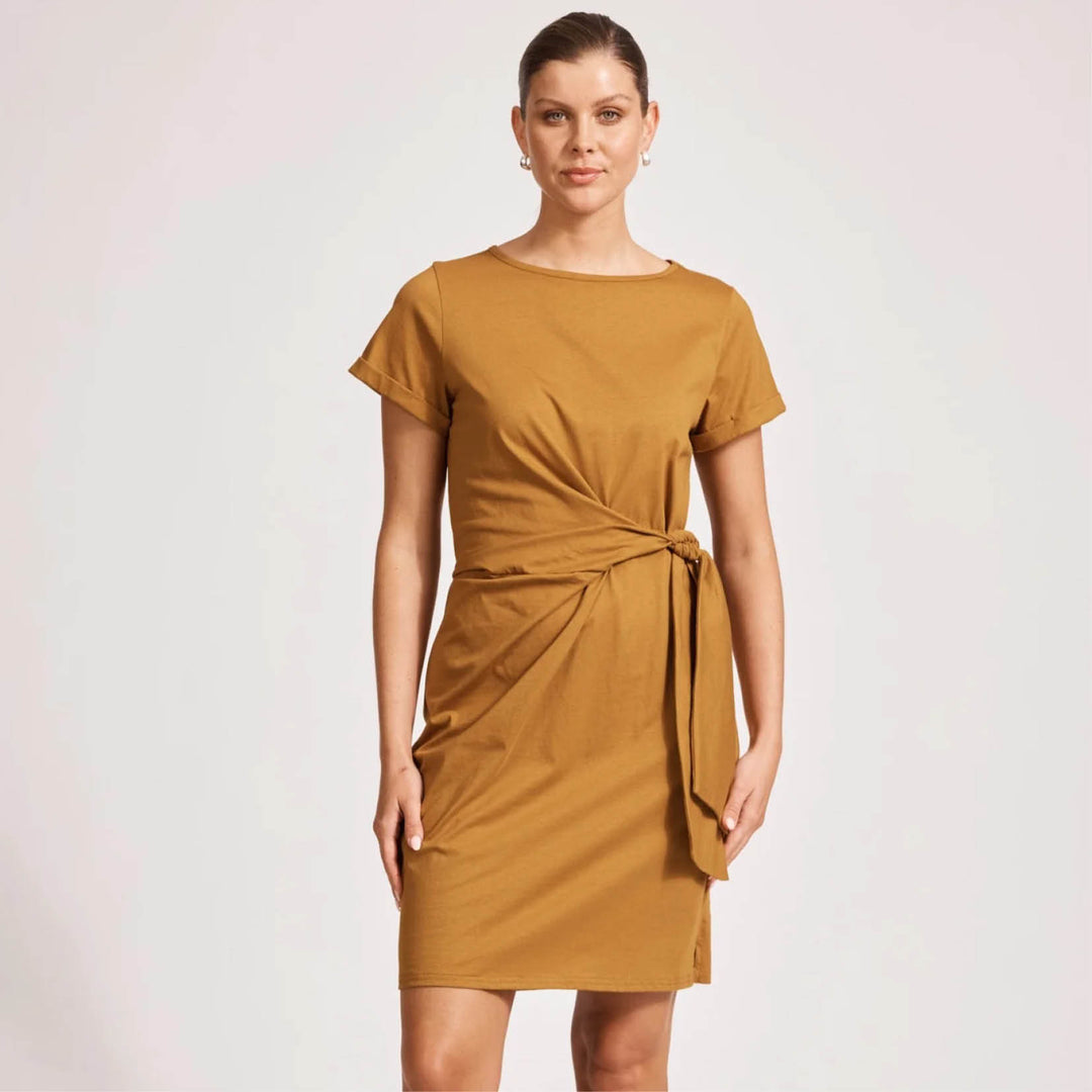 Woman wearing a eb & ive mustard yellow dress on a white background