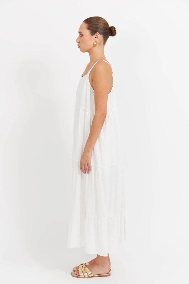 Woman wearing a Haven white dress on a white background