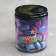 Clear jar with colorful candies labeled 'SWEETA' on a light gray background