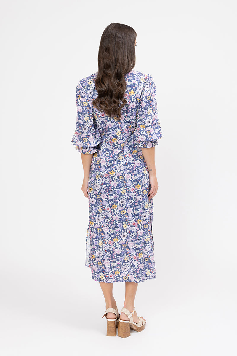 Woman wearing a floral dress on a white background