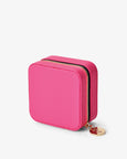 Pink jewelry case with gold zipper on a white background